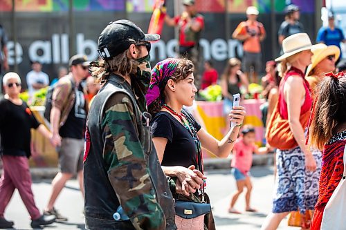 MIKAELA MACKENZIE / WINNIPEG FREE PRESS

Cambria Harris films a round dance at Portage and Main calling for the landfills to be searched on Thursday, Aug. 3, 2023. For Tessa story.
Winnipeg Free Press 2023