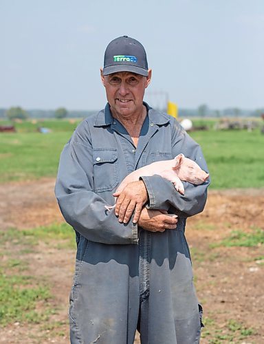 Mike Thiessen / Winnipeg Free Press 
Ian Smith with one of his two-day-old piglets. Smith, a small-scale pork farmer, feels that large corporations have taken over the pork industry, making it increasingly difficult for smaller producers like himself to make a living. For Gabrielle Pich&#xe9;. 230803 &#x2013; Thursday, August 3, 2023