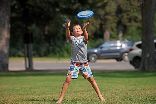 03082023
Eight-year-old Madden Dyck catches a frisbee while playing with his dad and a family friend in Wasagaming on a hot Thursday. 
(Tim Smith/The Brandon Sun)