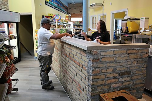 Karla Ortega serves a customer at the new location of Karla's International Foods on the 900 block of Rosser Avenue. (Abiola Odutola/The Brandon Sun)