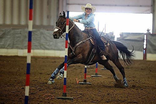 Breanna Linders weaves through poles atop her horse during the high school pole bending event on Friday. (Photos by Tim Smith/The Brandon Sun)