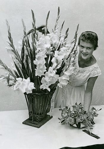 GERRY CAIRNS / WINNIPEG FREE PRESS

Free Press photographer Gerry Cairns spotted a girl in a white dress and asked her to pose with the gladiolas at a downtown Winnipeg garden show in 1955.
By the next weekend, they were a couple, and, by 1957, he and Lorraine were married.