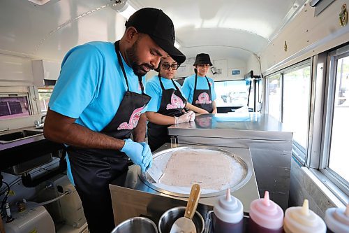 RUTH BONNEVILLE / WINNIPEG FREE PRESS

ENT - Shake N Rolls

Photo of newlyweds, Param and Kulpreet Gill (left and centre) owners of Shake N Rolls, making rolled ice cream in their pink school bus food truck.  

Story: Newlyweds, Param and Kulpreet Gill, owners of newly opened Shake N Rolls, hat makes rolled ice cream in their pink food truck that has been attracting long lineups for their east Indian-inspired flavours.

Eva Wasney story

August 3rd,  2023

