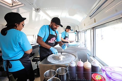 RUTH BONNEVILLE / WINNIPEG FREE PRESS

ENT - Shake N Rolls

Photo of newlyweds, Param and Kulpreet Gill (left Kulpreet and Param in centre) owners of Shake N Rolls, making rolled ice cream in their pink school bus food truck.  

Story: Newlyweds, Param and Kulpreet Gill, owners of newly opened Shake N Rolls, hat makes rolled ice cream in their pink food truck that has been attracting long lineups for their east Indian-inspired flavours.

Eva Wasney story

August 3rd,  2023


