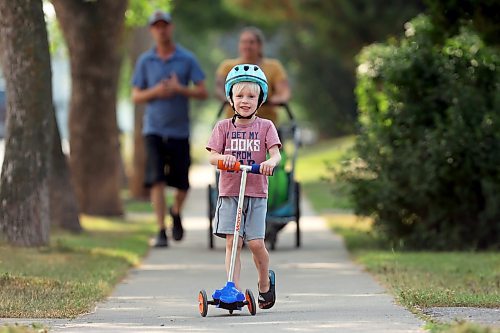Rudy Kuipers scooters along Aberdeen Avenue while heading to the park with family on a sunny Monday afternoon. 
(Tim Smith/The Brandon Sun)