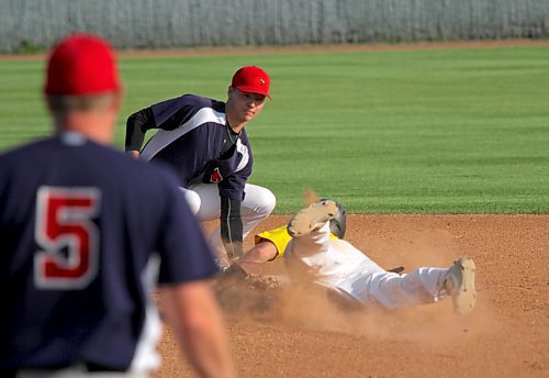 GW Vacuum Truck Service Young Guns shortstop Garrett Popplestone dodges the tag of RFNOW Cardinals shortstop Paycen Warkentin to steal second base during Game 2 of the Andrew Agencies Senior AA Baseball League final at Andrews Field on Tuesday. The Young Guns racked up five runs in the seventh inning to win 6-1 and tie the best-of-five series 1-1. Dylan Haney earned the win on the mound. (Thomas Friesen/The Brandon Sun)
