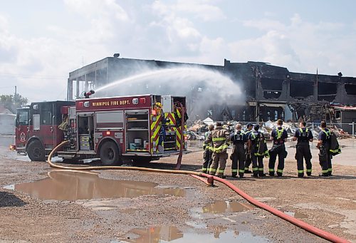 Mike Thiessen / Winnipeg Free Press 
A Winnipeg Fire Department crew continues to water down the site of Sunday&#x2019;s fire at Anco Lumber on Logan Avenue. For Joyanne Pursaga. 230808 &#x2013; Tuesday, August 8, 2023