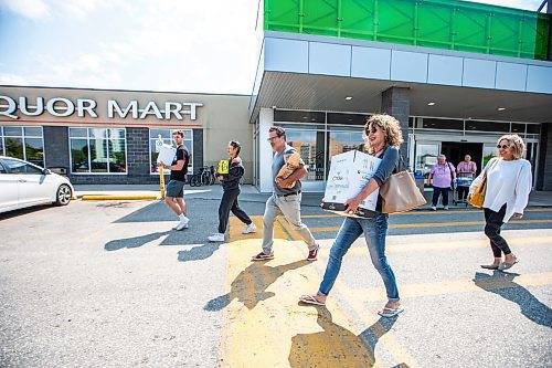 MIKAELA MACKENZIE / WINNIPEG FREE PRESS

Ashton Thompson (left), Cena Murphy, Scott Irving, Kim Irving, and Kelly Thompson walk out of the Grant Park Liquor Mart (with alcohol purchased for a trip to the cabin) on Tuesday, Aug. 8, 2023. For Malak Abas story.
Winnipeg Free Press 2023