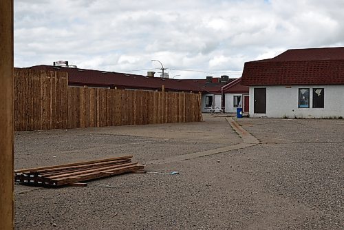 The construction of a privacy fence, as a condition for a zoning variance application, is being completed at the Redwood Motor Inn. The motel, under new ownership, is being transformed into a transitional housing facility to reunite mothers who have completed addiction treatment with their children. (Geena Mortfield/The Brandon Sun)