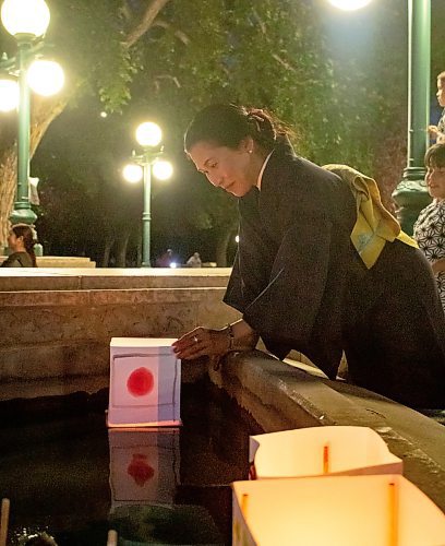 Mike Thiessen / Winnipeg Free Press 
Junko Bailey, of the Japanese Cultural Association of Manitoba, launches a lantern into the Legislative building&#x2019;s south fountain at the Lanterns for Peace event. For Tessa Adamski. 230809 &#x2013; Wednesday, August 9, 2023