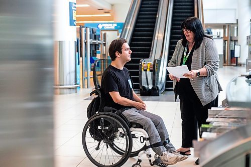 MIKAELA MACKENZIE / WINNIPEG FREE PRESS

Christina Redmond, director of terminal operations with the Winnipeg Airport Authority, shows Luke Armbruster, administrative assistant with Inclusion Winnipeg, the infomation desk during a passenger rehearsal program tour at the Winnipeg Richardson International Airport on Tuesday, Aug. 8, 2023. With this program, travelers with disabilities are invited to check out the security and boarding process before they fly. For Eva Wasney story.
Winnipeg Free Press 2023