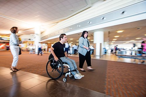 MIKAELA MACKENZIE / WINNIPEG FREE PRESS

Christina Redmond, director of terminal operations with the Winnipeg Airport Authority, walks Luke Armbruster, administrative assistant with Inclusion Winnipeg, through the terminal during a passenger rehearsal program tour at the Winnipeg Richardson International Airport on Tuesday, Aug. 8, 2023. With this program, travelers with disabilities are invited to check out the security and boarding process before they fly. For Eva Wasney story.
Winnipeg Free Press 2023