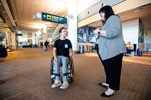 MIKAELA MACKENZIE / WINNIPEG FREE PRESS

Christina Redmond, director of terminal operations with the Winnipeg Airport Authority, walks Luke Armbruster, administrative assistant with Inclusion Winnipeg, through the terminal during a passenger rehearsal program tour at the Winnipeg Richardson International Airport on Tuesday, Aug. 8, 2023. With this program, travelers with disabilities are invited to check out the security and boarding process before they fly. For Eva Wasney story.
Winnipeg Free Press 2023