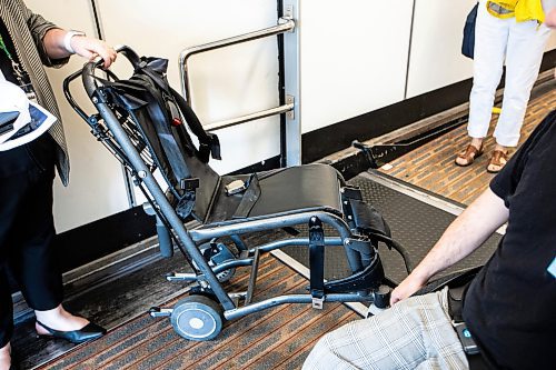 MIKAELA MACKENZIE / WINNIPEG FREE PRESS

Christina Redmond, director of terminal operations with the Winnipeg Airport Authority, shows Luke Armbruster, administrative assistant with Inclusion Winnipeg, the aisle chair during a passenger rehearsal program tour at the Winnipeg Richardson International Airport on Tuesday, Aug. 8, 2023. With this program, travelers with disabilities are invited to check out the security and boarding process before they fly. For Eva Wasney story.
Winnipeg Free Press 2023