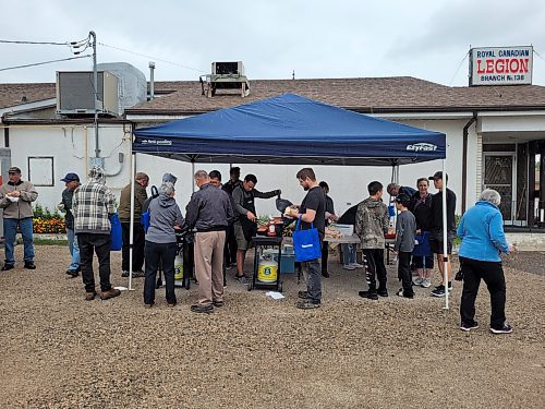 Despite the rain, constituents from Member of Parliament Dan Mazier's Dauphin-Swan River-Neepawa riding came out to the community barbecue and popup passport service he hosted in Minnedosa on Aug. 10. (Miranda Leybourne/The Brandon Sun)