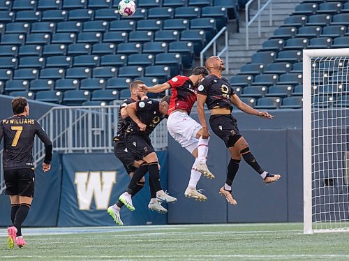 Mike Thiessen / Winnipeg Free Press 
Valour FC players jump for the ball during the team&#x2019;s match against Cavalry FC on Friday. For Joshua Sam-Frey. 230811 &#x2013; Friday, August 11, 2023