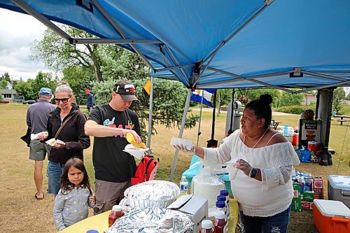 Visitors to the First HAMI Hispanic Festival grab hot dogs at Rideau Park on Saturday. (Colin Slark/The Brandon Sun)