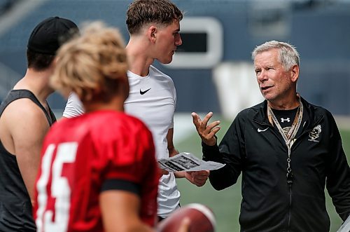 JOHN WOODS / WINNIPEG FREE PRESS
University of Manitoba Bisons coach Brian Dobey talks to quarterback Jackson Tachinski (14) at practice in Winnipeg, Sunday, August 13, 2023. 

Reporter: taylor