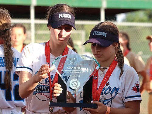 Fraser Valley Fusion players Macy Reimer, left, and Ava Dudar study the trophy their team won after defeating the UTM Bandits 12-1 in the top division final at Softball Canada&#x2019;s under-15 national girls softball championship on Sunday evening. A dedicated team of volunteers were key to keeping the young women on the field after rainy conditions soaked the facility over the last few days. (Perry Bergson/The Brandon Sun)
Aug. 13, 2023