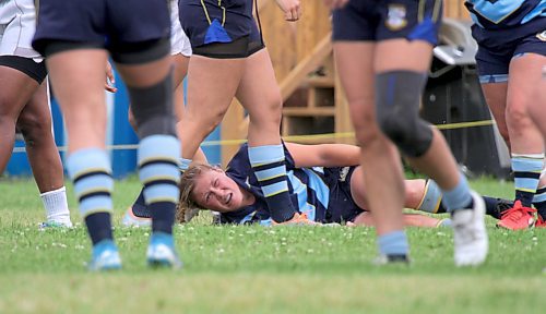 Avery Brennan of the Brandon Barbarians winces on the ground after a tackle against the Winnipeg Assassins in Rugby Manitoba premier women's league action at John Reilly Field on Saturday. (Thomas Friesen/The Brandon Sun)