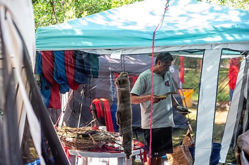 MIKAELA MACKENZIE / WINNIPEG FREE PRESS

Firekeeper Shining Goldstar smudges at Camp Marcedes (beside the Canadian Museum for Human Rights) on Monday, Aug. 14, 2023. For Cierra Bettens story.
Winnipeg Free Press 2023