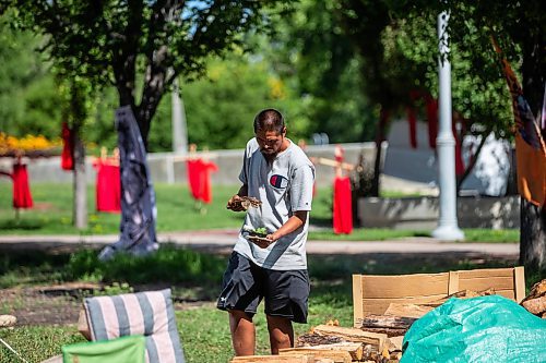 MIKAELA MACKENZIE / WINNIPEG FREE PRESS

Firekeeper Shining Goldstar smudges around Camp Marcedes (beside the Canadian Museum for Human Rights) on Monday, Aug. 14, 2023. For Cierra Bettens story.
Winnipeg Free Press 2023