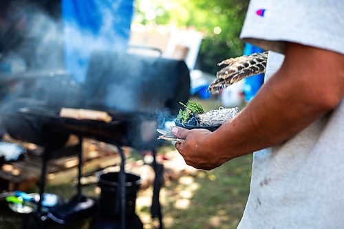 MIKAELA MACKENZIE / WINNIPEG FREE PRESS

Firekeeper Shining Goldstar smudges at Camp Marcedes (beside the Canadian Museum for Human Rights) on Monday, Aug. 14, 2023. For Cierra Bettens story.
Winnipeg Free Press 2023