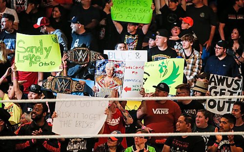 JOHN WOODS / WINNIPEG FREE PRESS
people hold signs at WWE in Winnipeg, Monday, August 14, 2023. 

Reporter: mcintyre