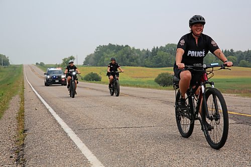 Cst. Amanda Conway with Brandon Police Service cycles up front with Cst. Selena Samagalski and Cst. Meghan Puteran close behind. Cst. Denis Dufault operates the police cruiser for safety. The four BPS officers accompanied Shilo soldier Rob Nederlof from Brandon to Shilo on his 1,000 kms trek to raise funds and awareness for the Wounded Warrior PTSD Service Dogs program on Tuesday. (Michele McDougall/The Brandon Sun)

 (Michele McDougall/The Brandon Sun)
