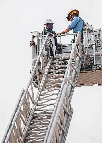 JOHN WOODS / WINNIPEG FREE PRESS
Mariam Wancha, who came from Ethiopia in 2019, goes up in the bucket of a ladder truck at the Winnipeg Fire Paramedic Service (WFPS) training academy in Winnipeg, Tuesday, August 15, 2023. The WFPS hosted 36 newcomer youth at a two-day skills training career camp.

Reporter: cierra