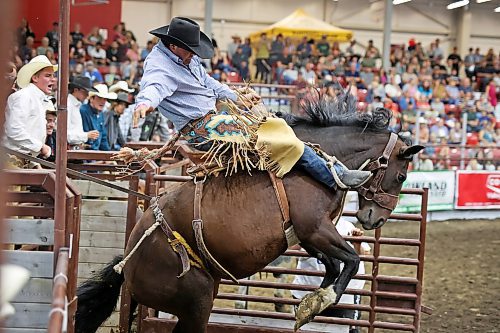 Aidan Jeffery, of Tumut, Australia, bursts out of the gate atop his horse during the Saddle Bronc event during the Virden Indoor Rodeo Friday evening. (Tim Smith/The Brandon Sun)