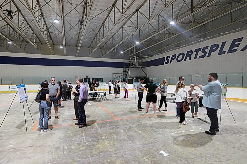 City staff and representatives from consulting firms speak with members of the public about potential renovation options for the future of the Sportsplex at an open house on Wednesday afternoon. (Colin Slark/The Brandon Sun)
