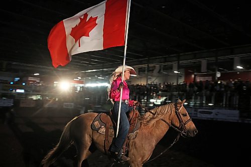 18082023
A rider carries the Canadian flag during the national anthem at the Friday night go round of the Virden Indoor Rodeo at Tundra Oil &amp; Gas Place. (Tim Smith/The Brandon Sun)