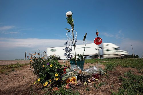 20062023
A semi trailer pass by flowers and other items placed at the intersection of the Trans Canada Highway and Highway 5 just north of Carberry as a memorial to the victims of last weeks devastating collision involving a semi trailer and a passenger bus carrying seniors from Dauphin to the Sand Hills Casino.   (Tim Smith/The Brandon Sun)