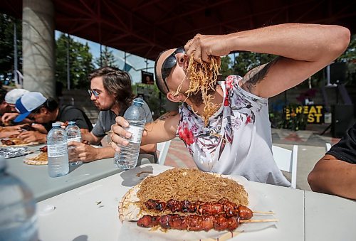 JOHN WOODS / WINNIPEG FREE PRESS
MacKenzie Falk competes in an eating contest of philippine pancit and bbq pork during Streat Feast at the Forks in Winnipeg, Sunday, August  20, 2023. 

Reporter: standup