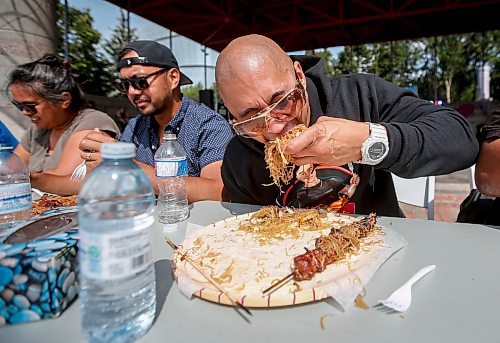 JOHN WOODS / WINNIPEG FREE PRESS
Brian Duaqui competes at an eating contest of philippine pancit and bbq pork during Streat Feast at the Forks in Winnipeg, Sunday, August  20, 2023. 

Reporter: standup