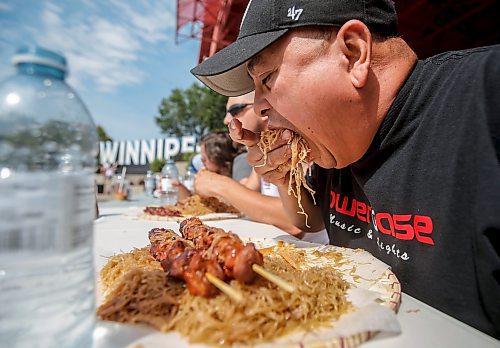 JOHN WOODS / WINNIPEG FREE PRESS
Joenar Jovellano competes at an eating contest of philippine pancit and bbq pork during Streat Feast at the Forks in Winnipeg, Sunday, August  20, 2023. 

Reporter: standup