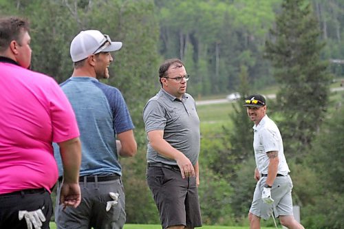 Dustin Dyck tosses his hat and putter after saving par to qualify for the championship flight, as friends Terrill Swaney, left, and Blaine Wells look on and cheer. (Thomas Friesen/The Brandon Sun)