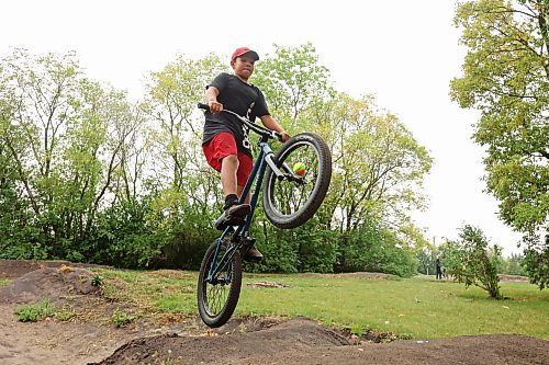 21082023
Ryan Houle sails over a jump at the bike tracks on 3rd Street in Brandon’s south end while biking with friends on Monday. 
(Tim Smith/The Brandon Sun)