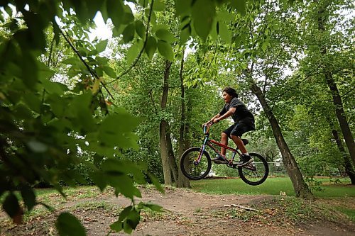 Chancellor John Dyck Beardy rips around the bike tracks on 3rd Street in Brandon’s south end while biking with friends on Monday. 
(Tim Smith/The Brandon Sun)