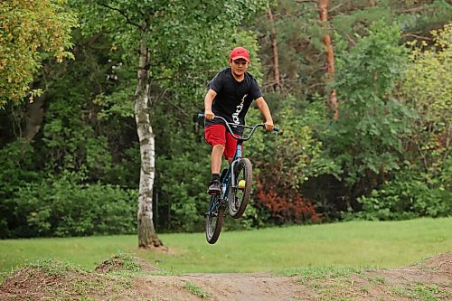 21082023
Ryan Houle sails over a jump at the bike tracks on 3rd Street in Brandon&#x2019;s south end while biking with friends on Monday. 
(Tim Smith/The Brandon Sun)