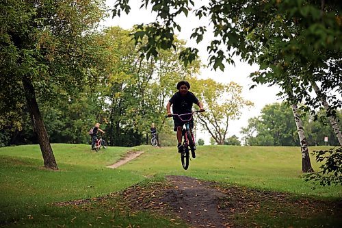 21082023
Chancellor John Dyck Beardy rips around the bike tracks on 3rd Street in Brandon&#x2019;s south end while biking with friends on Monday. 
(Tim Smith/The Brandon Sun)