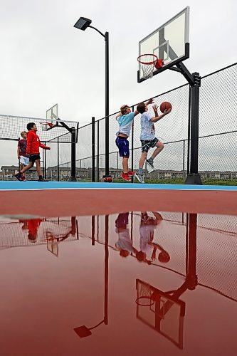 Friends Zach Nickel, Uan Lizada, Jordan Nickel and Spencer Simpson play basketball together at the Jumpstart Multi Sport Court on Maryland Avenue in Brandon’s south end on a grey Tuesday. 
(Tim Smith/The Brandon Sun)