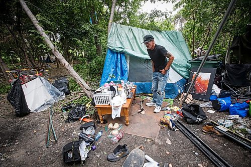 JOHN WOODS / WINNIPEG FREE PRESS
Terry Johnsen, who was evicted from the Adanac Apartments on Sargent Ave., has set up camp on the Assiniboine River bank in Winnipeg Tuesday, August  22, 2023. Johnsen has been living there for two weeks eversince fired and water damaged his suite at the block.

Reporter: searle