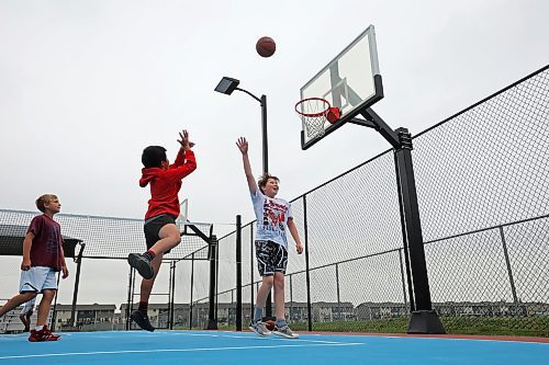 22082023
Zach Nickel, Uan Lizada and Spencer Simpson play basketball with friends at the Jumpstart Multi Sport Court on Maryland Avenue in Brandon&#x2019;s south end on a grey Tuesday. 
(Tim Smith/The Brandon Sun)