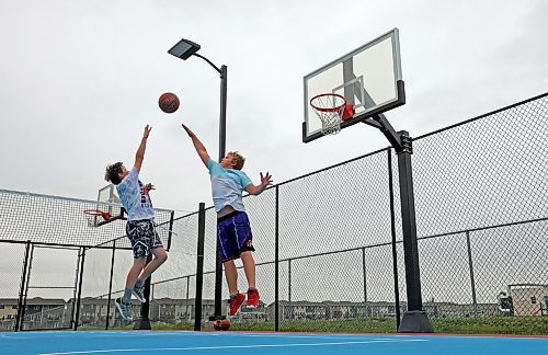 22082023
Spencer Simpson and Jordan Nickel play basketball with friends at the Jumpstart Multi Sport Court on Maryland Avenue in Brandon&#x2019;s south end on a grey Tuesday. 
(Tim Smith/The Brandon Sun)