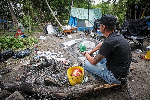 JOHN WOODS / WINNIPEG FREE PRESS
Terry Johnsen, who was evicted from the Adanac Apartments on Sargent Ave., has set up camp on the Assiniboine River bank in Winnipeg Tuesday, August  22, 2023. Johnsen has been living there for two weeks eversince fired and water damaged his suite at the block.

Reporter: searle