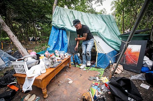 JOHN WOODS / WINNIPEG FREE PRESS
Terry Johnsen, who was evicted from the Adanac Apartments on Sargent Ave., has set up camp on the Assiniboine River bank in Winnipeg Tuesday, August 22, 2023. Johnsen has been living there for two weeks eversince fired and water damaged his suite at the block.
Reporter: searle