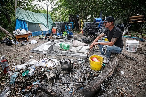 JOHN WOODS / WINNIPEG FREE PRESS
Terry Johnsen, who was evicted from the Adanac Apartments on Sargent Ave., has set up camp on the Assiniboine River bank in Winnipeg Tuesday, August 22, 2023. Johnsen has been living there for two weeks eversince fired and water damaged his suite at the block.
Reporter: searle