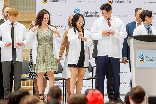 MIKE DEAL / WINNIPEG FREE PRESS
Jessica Li (centre) and her brother Jeffrey Li (right) during the White Coat Ceremony.
Family, friends and medical dignitaries gather in the Brodie Centre Atrium, Bannatyne Campus, 727 McDermot Avenue, for the University of Manitoba&#x2019;s Inaugural Day Exercises of the largest medical class in University of Manitoba history, the Class of 2027. The Max Rady College of Medicine will see 125 incoming medical students this coming year up from 110 students in recent years. During the event the new students take part in the White Coat Ceremony and recite the Physician&#x2019;s Pledge.
See Tessa Adamski story 
230823 - Wednesday, August 23, 2023.